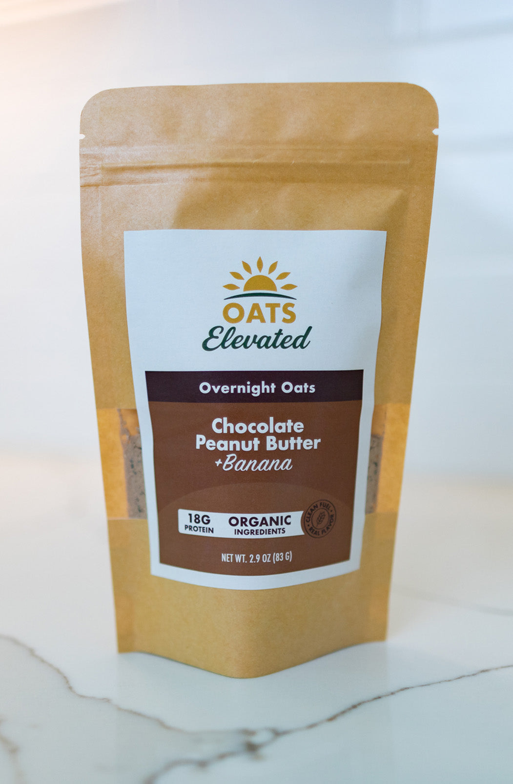 Front of package of Oats Elevated Chocolate Peanut Butter plus Banana Overnight Oats with organic ingredients, high-protein breakfast.