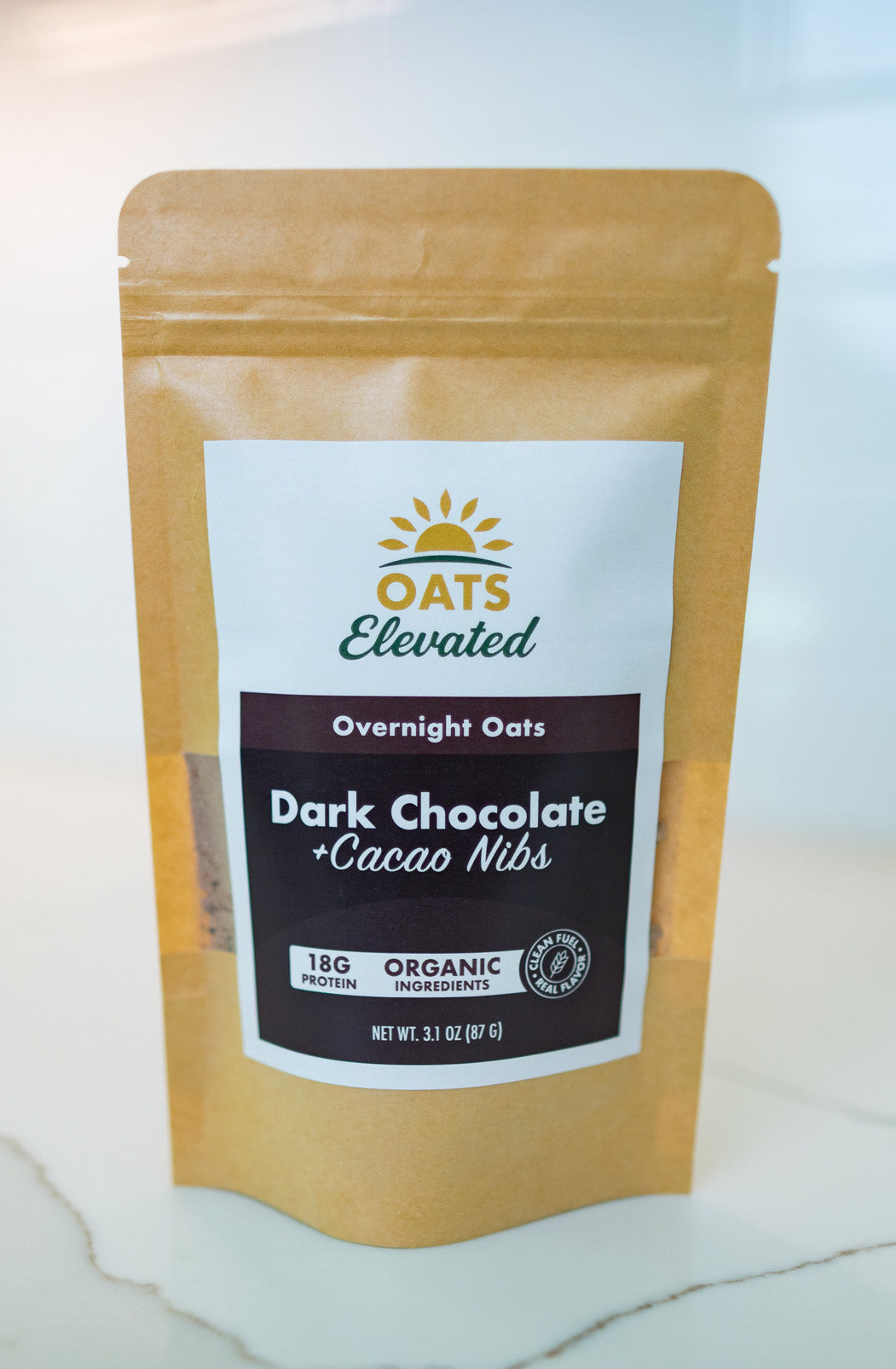 Front of package of Oats Elevated Dark Chocolate plus Cacao Nibs Overnight Oats with organic ingredients, high-protein breakfast.